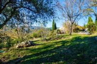 a park with trees and a bench in the grass at Villa Provence Vue Panoramique - in Fayence