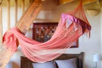 a hammock hanging over a bed in a room at Villa Provence Vue Panoramique - in Fayence