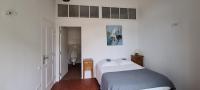 a bedroom with a bed and a bathroom with a toilet at Gîte Marronnier in Tourrettes-sur-Loup