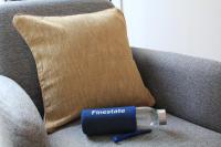 a fire whistle sitting on a couch next to a pillow at FINESTATE Coliving Champs-Elysées in Paris