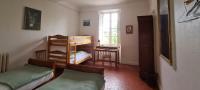 a room with two beds and a desk and a window at Gîte Marronnier in Tourrettes-sur-Loup