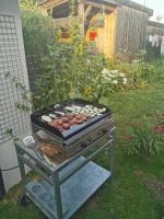 a grill in a yard with food on it at Standing, calm &amp; confort. in Bègles