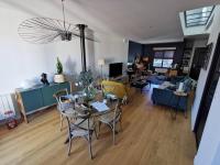 a living room with a table and chairs at Standing, calm &amp; confort. in Bègles