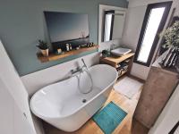 a bathroom with a white tub and a sink at Standing, calm &amp; confort. in Bègles