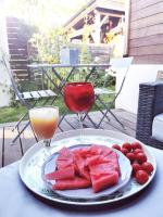 a plate of watermelon and fruit and two glasses of wine at Standing, calm &amp; confort. in Bègles