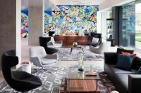 a lobby with couches and chairs and a mural at Le Méridien Chicago - Oakbrook Center in Oak Brook