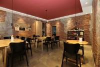 a restaurant with brick walls and tables and chairs at Beijing MutianyuGreat Wall Let'sgo Hotel&Bar in Huairou