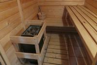 a inside of a sauna with a stove in it at Chalet Beaujon Chapelle-des-Bois in Chapelle-des-Bois