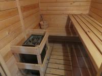 an inside of a wooden sauna with a tub at Chalet Beaujon Chapelle-des-Bois in Chapelle-des-Bois