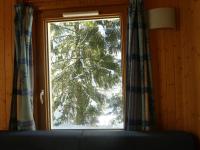 a window with a view of a snow covered tree at Chalet Beaujon Chapelle-des-Bois in Chapelle-des-Bois