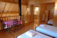 a room with a table and a bed and a dining room at Chalet Beaujon Chapelle-des-Bois in Chapelle-des-Bois