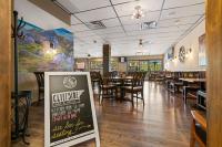 a dining room with tables and chairs and a sign at Remodeled Tamarron Lodge unit - Amazing views and 10 miles to Purgatory! in Durango