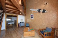 a living room with a surfboard hanging on the wall at VENEZ SEJOURNER A GRUISSAN ....PLAGE DES CHALETS in Gruissan