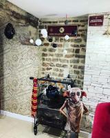 a statue of a person in a room with a brick wall at Les sorciers, la Diligence St Jean de Losne in Saint-Jean-de-Losne