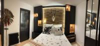 a bedroom with a bed with a headboard and pillows at Appartement vue Tour Eiffel paris 16 Eme in Paris