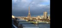 a view of the eiffel tower and a river at Appartement vue Tour Eiffel paris 16 Eme in Paris
