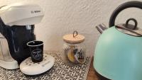a coffee maker and a jar on a table at Blois City - Le Petit Saint Jean in Blois