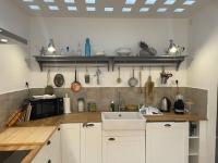 a kitchen with a sink and a microwave at Gite sur la Founintrouze in Fabrezan