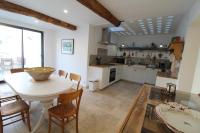 a kitchen and dining room with a table and chairs at Gite sur la Founintrouze in Fabrezan