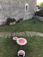 a table and chairs in a yard with a table and chairs at Lou Bohème in Le Briou