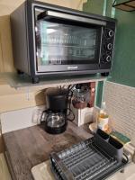 a microwave oven sitting on top of a kitchen counter at La paillote idyllique in Faverolles-sur-Cher