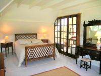 a bedroom with a bed and a desk and a mirror at Grand Clos Normand in Varengeville-sur-Mer