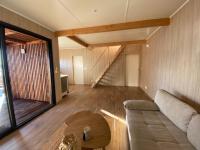 a living room with a couch and a table at HAVRE DE PAIX LES PIEDS DANS L&#39;EAU in Istres