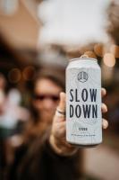 a person holding up a slow down can at The Village Inn in East Burke