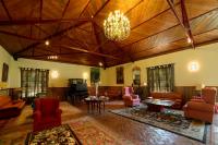 a large living room with furniture and a chandelier at Hotel Hacienda Montenmedio in Vejer de la Frontera