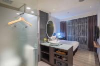 a bathroom with a sink and a mirror and a shower at CHECK inn Taipei Xinyi in Taipei