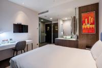 a hotel room with a bed and a bathroom at CHECK inn Taipei Xinyi in Taipei