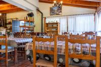 a dining room with tables and chairs and a chandelier at Hotel Uña Serranía Encantada in Uña