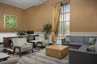 a living room with a couch and chairs and a desk at DoubleTree by Hilton Chicago O'Hare Airport-Rosemont in Rosemont