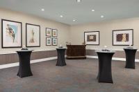 a room with black tables and pictures on the wall at DoubleTree by Hilton Chicago O'Hare Airport-Rosemont in Rosemont