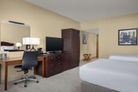 a hotel room with a bed and a desk with a computer at DoubleTree by Hilton Chicago O'Hare Airport-Rosemont in Rosemont
