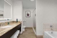 a bathroom with a sink and a toilet and a tub at DoubleTree by Hilton Chicago O'Hare Airport-Rosemont in Rosemont