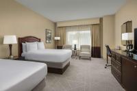 a hotel room with two beds and a desk at DoubleTree by Hilton Chicago O'Hare Airport-Rosemont in Rosemont
