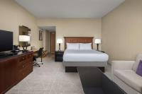 a bedroom with a bed and a desk and a tv at DoubleTree by Hilton Chicago O'Hare Airport-Rosemont in Rosemont