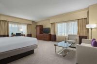 a large hotel room with a bed and a couch at DoubleTree by Hilton Chicago O'Hare Airport-Rosemont in Rosemont