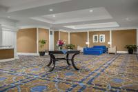 a lobby with a table in the middle of a room at DoubleTree by Hilton Chicago O'Hare Airport-Rosemont in Rosemont