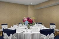 a table with a vase of flowers on it at DoubleTree by Hilton Chicago O'Hare Airport-Rosemont in Rosemont