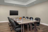 a conference room with a long table and black chairs at DoubleTree by Hilton Chicago O'Hare Airport-Rosemont in Rosemont