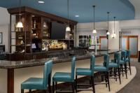 a bar with blue chairs in a hotel room at DoubleTree by Hilton Chicago O'Hare Airport-Rosemont in Rosemont