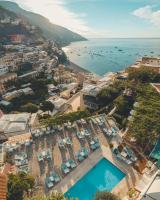 an aerial view of a resort with a pool and the ocean at Hotel Poseidon in Positano
