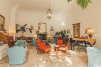 a living room with colorful chairs and a table at Hotel Poseidon in Positano
