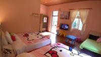 a childs bedroom with two beds and a television at Zhen Shan Zhuang B&amp;B in Yuanshan