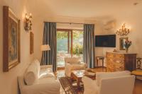 a living room with white furniture and a large window at Hotel Poseidon in Positano