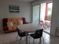 a living room with a table and chairs and a couch at Appartement Capbreton, 3 pièces, 4 personnes - FR-1-239-453 in Capbreton