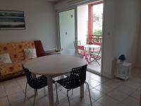a living room with a table and chairs and a couch at Appartement Capbreton, 3 pièces, 4 personnes - FR-1-239-453 in Capbreton