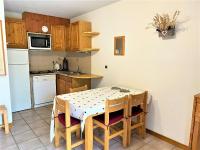 a kitchen with a table and chairs in a kitchen at Appartement Le Monêtier-les-Bains, 2 pièces, 4 personnes - FR-1-330F-225 in Le Reposoir